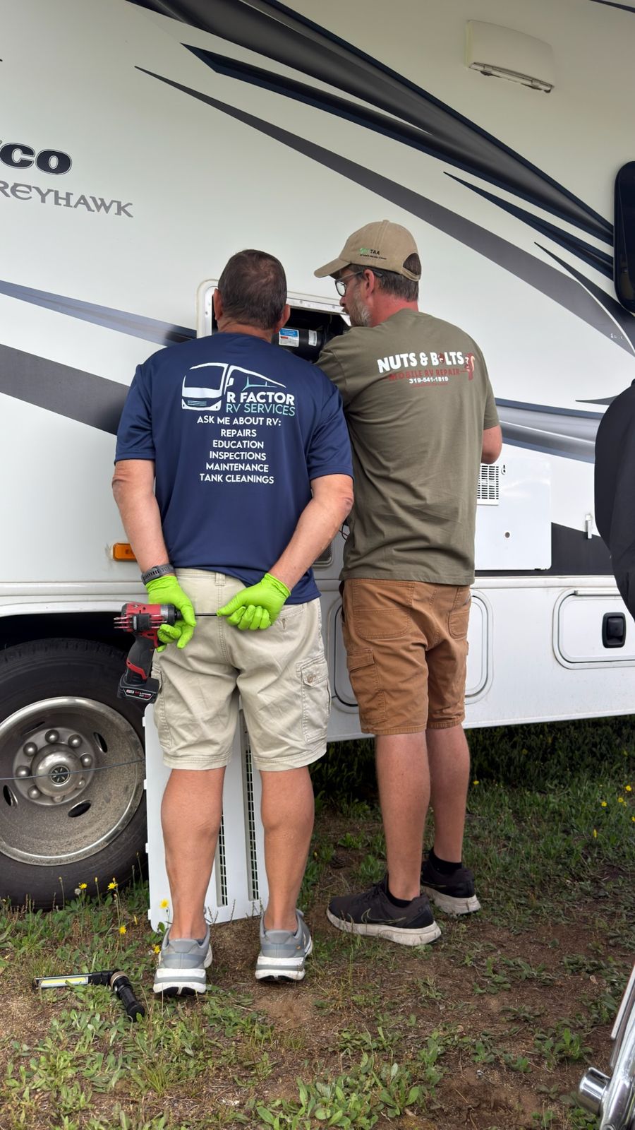 Technicians from two different companies diagnosing a problem together
