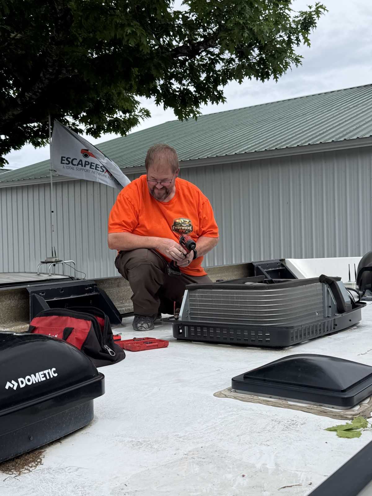 Rooftop air conditioner service under an Escapees flag