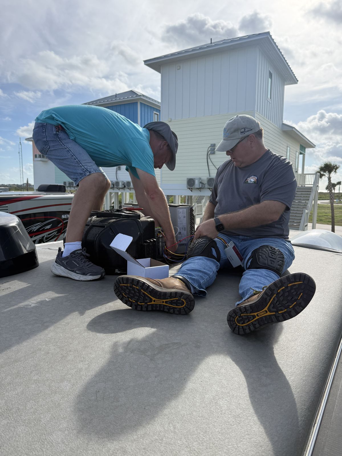 Two technicians working on an RV roof at the Texas Resort Getaway