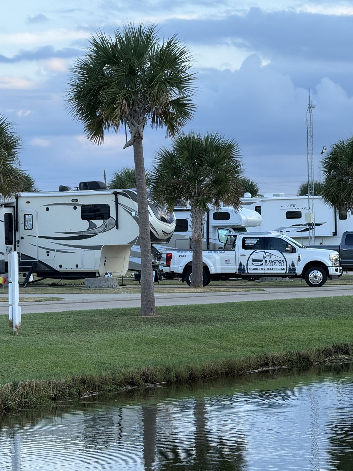 Service truck parked among palm trees at the resort