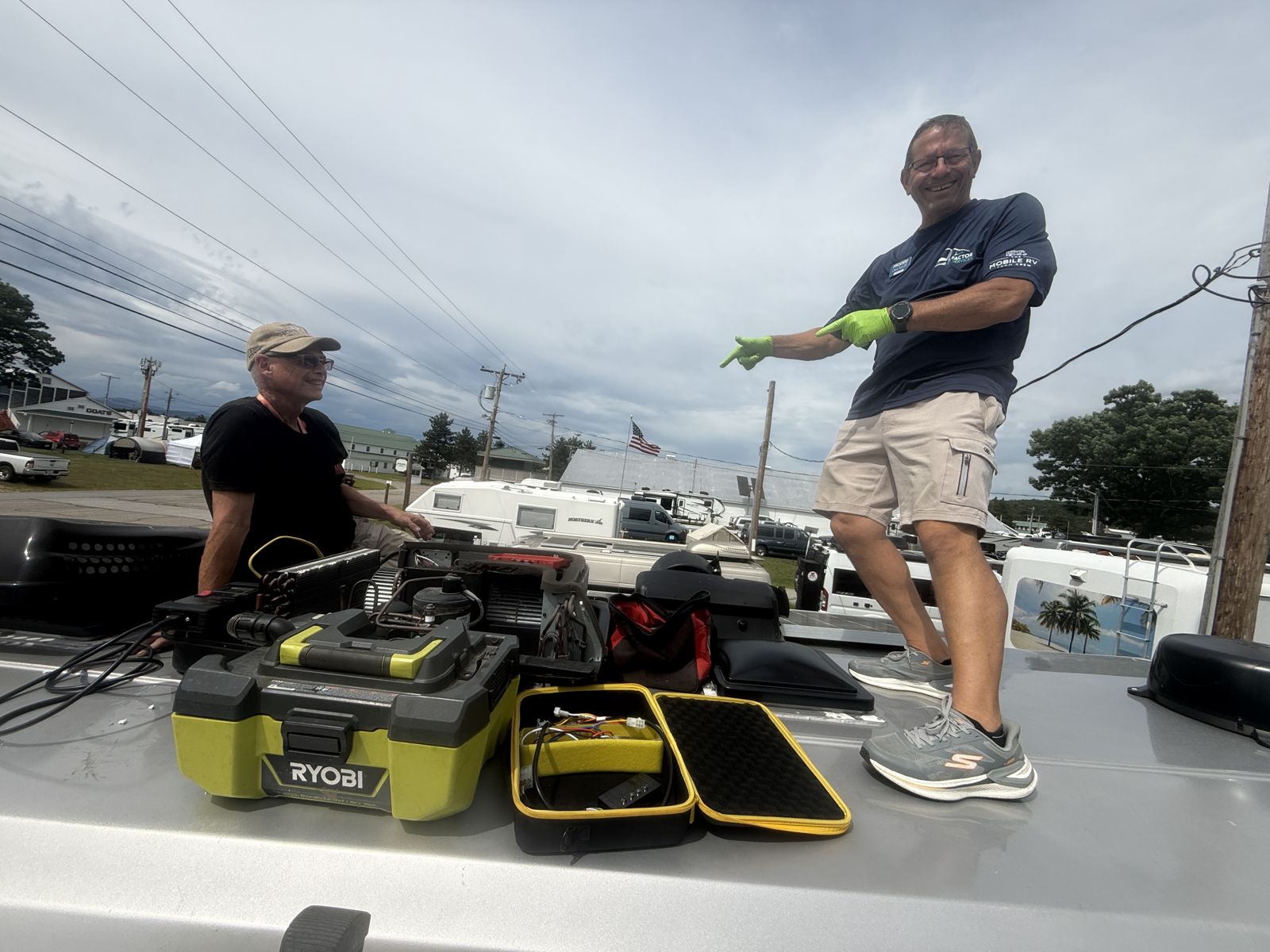 Two technicians on an RV roof at Escapade 2026