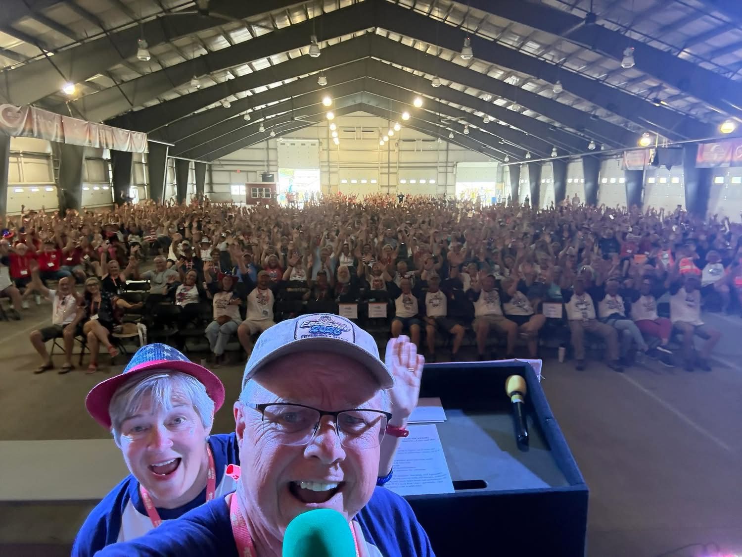A packed hall of attendees cheering at Escapade 2026